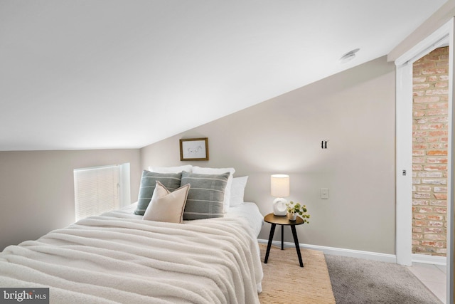 bedroom with light carpet and lofted ceiling