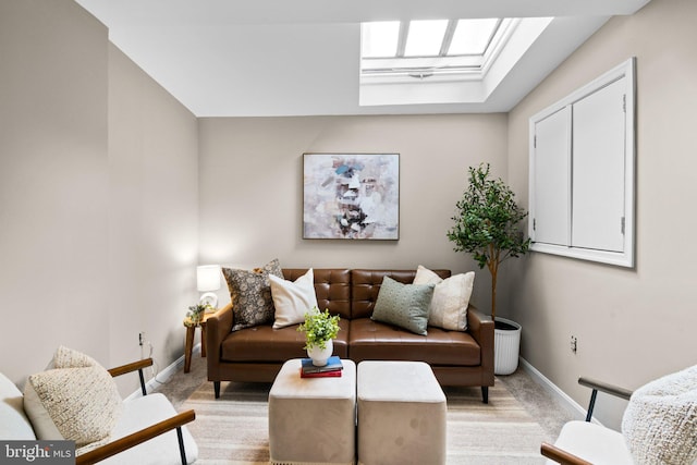 carpeted living room featuring a skylight