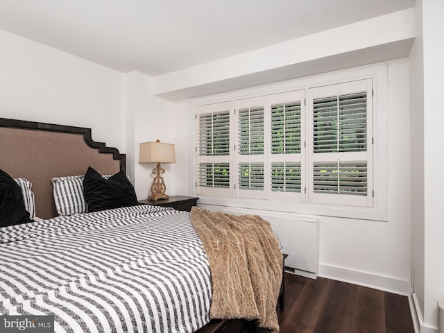 4201 Cathedral Ave NW Unit T10E, Washington, DC 20016 - bedroom featuring radiator, dark wood-style flooring, and baseboards