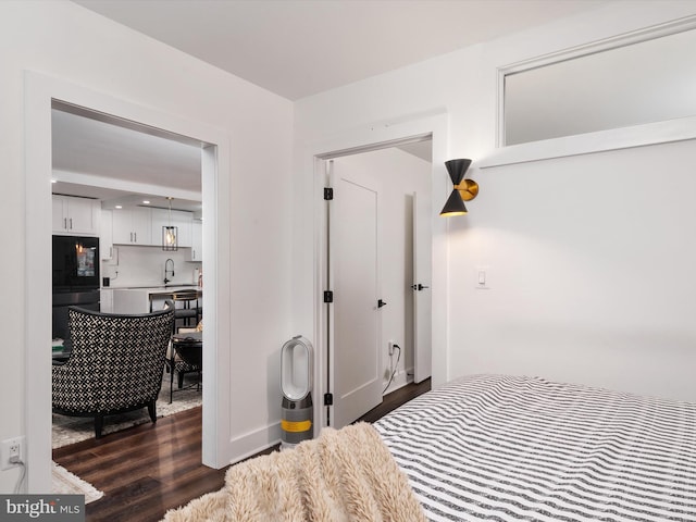 4201 Cathedral Ave NW Unit T10E, Washington, DC 20016 - unfurnished bedroom featuring freestanding refrigerator, dark wood-style flooring, and a sink