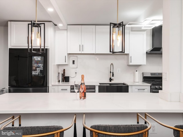 4201 Cathedral Ave NW Unit T10E, Washington, DC 20016 - kitchen with a sink, stainless steel gas range oven, refrigerator, wall chimney exhaust hood, and white cabinetry