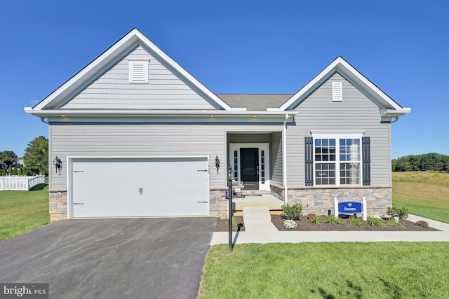 view of front of property featuring a garage and a front lawn