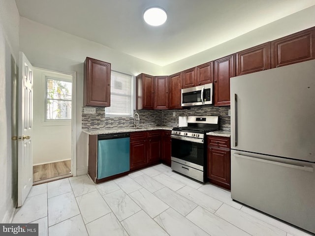 kitchen featuring sink, decorative backsplash, and appliances with stainless steel finishes