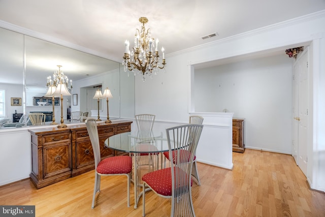 dining space featuring light hardwood / wood-style floors and ornamental molding