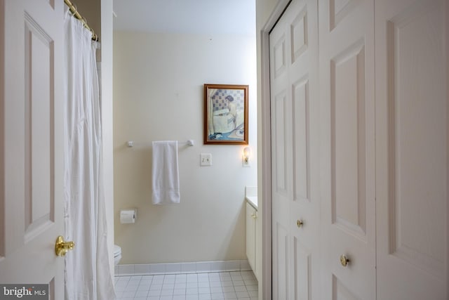 bathroom featuring tile patterned flooring, vanity, and toilet