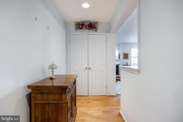 corridor with light hardwood / wood-style flooring