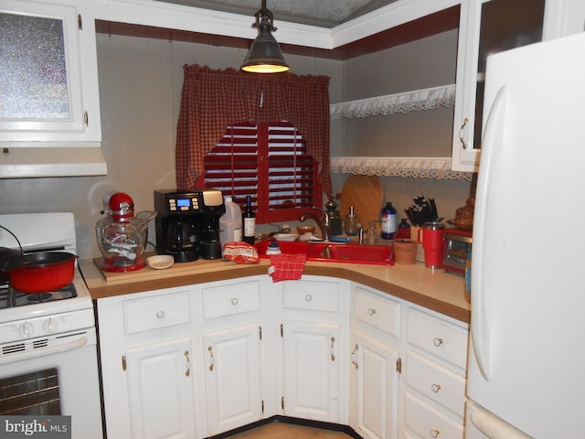 kitchen with pendant lighting, white appliances, white cabinets, crown molding, and sink