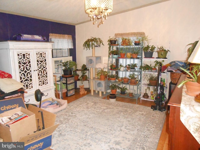 interior space featuring hardwood / wood-style floors, french doors, crown molding, and an inviting chandelier