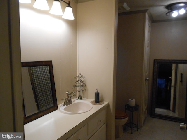 bathroom featuring tile patterned flooring, vanity, and toilet