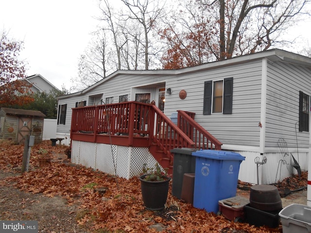 back of property with a wooden deck