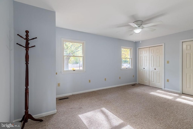 unfurnished bedroom featuring carpet and ceiling fan