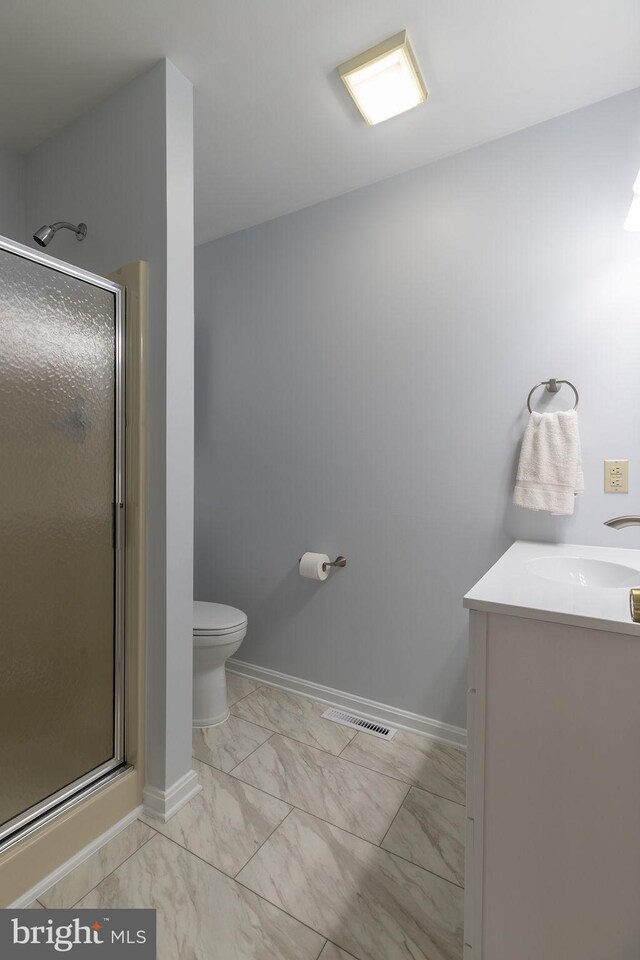 8 Crossgate Dr Unit 8, Seaford, DE 19973 - full bathroom featuring marble look tile flooring, a stall shower, toilet, vanity, and baseboards