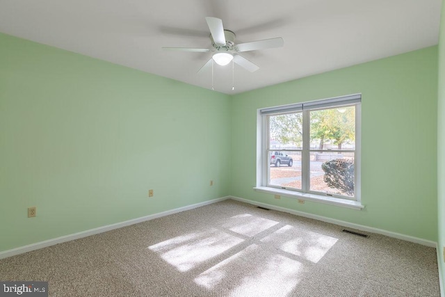 unfurnished room featuring ceiling fan and carpet floors