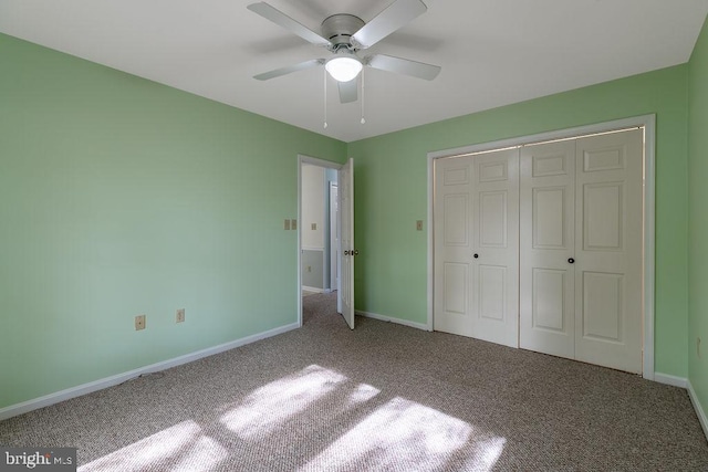 unfurnished bedroom with a closet, ceiling fan, and carpet floors