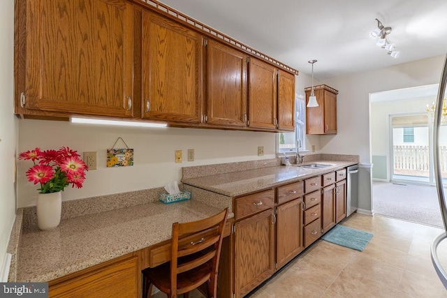 kitchen featuring a healthy amount of sunlight, sink, pendant lighting, and dishwasher