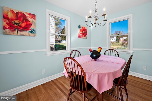 dining room featuring a wealth of natural light, a notable chandelier, and hardwood / wood-style flooring