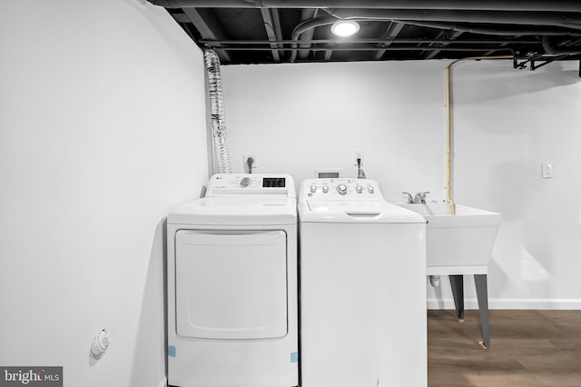 laundry room with hardwood / wood-style flooring and independent washer and dryer