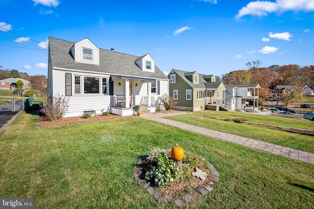 cape cod-style house with a front yard and covered porch