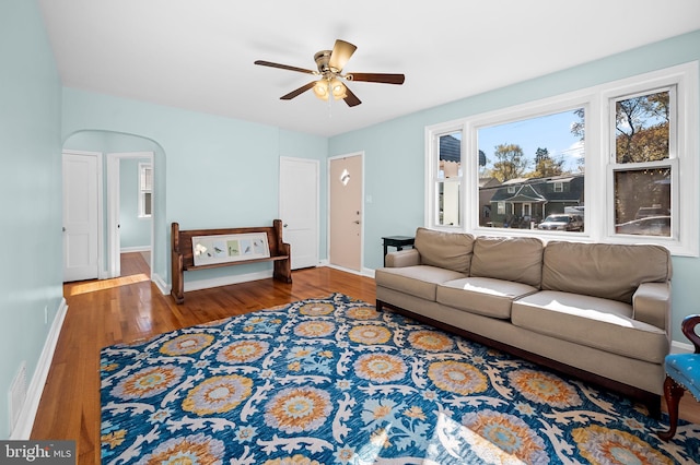 living room with ceiling fan and dark hardwood / wood-style floors