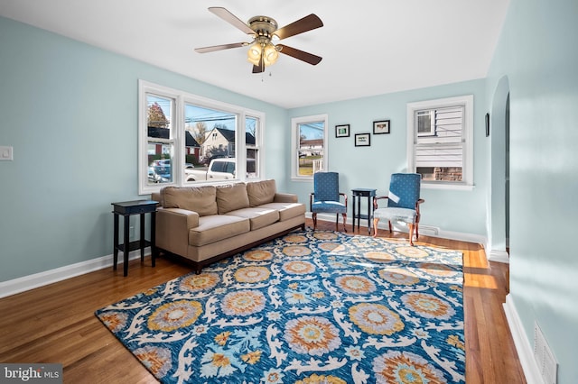 living room featuring hardwood / wood-style flooring and ceiling fan