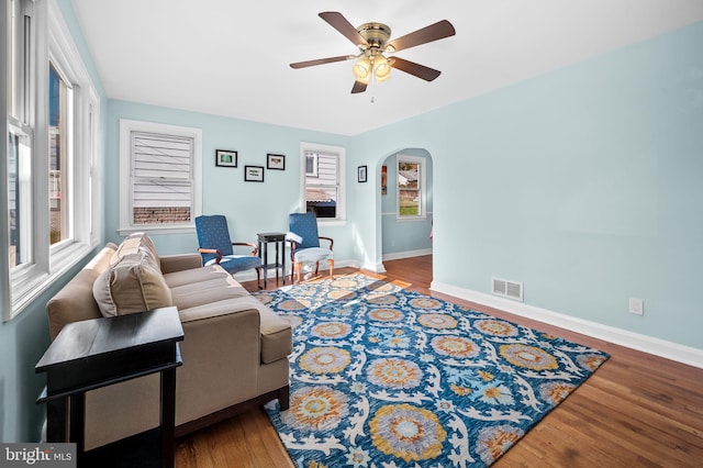 living room with ceiling fan, hardwood / wood-style floors, and a healthy amount of sunlight