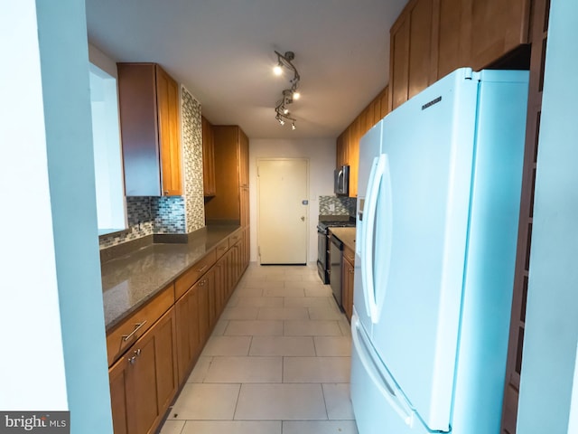 kitchen with tasteful backsplash, appliances with stainless steel finishes, and light tile patterned floors