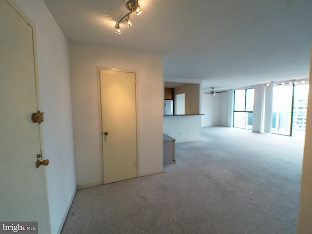 spare room featuring light colored carpet and ceiling fan