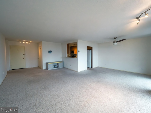 unfurnished living room with ceiling fan and carpet floors