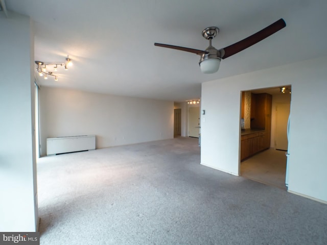 interior space featuring light colored carpet and ceiling fan