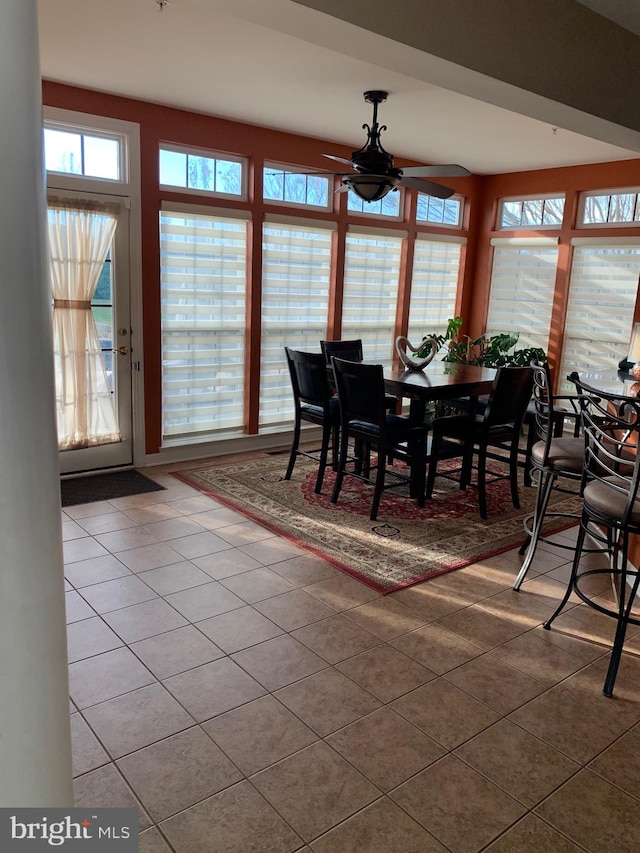 tiled dining space featuring ceiling fan