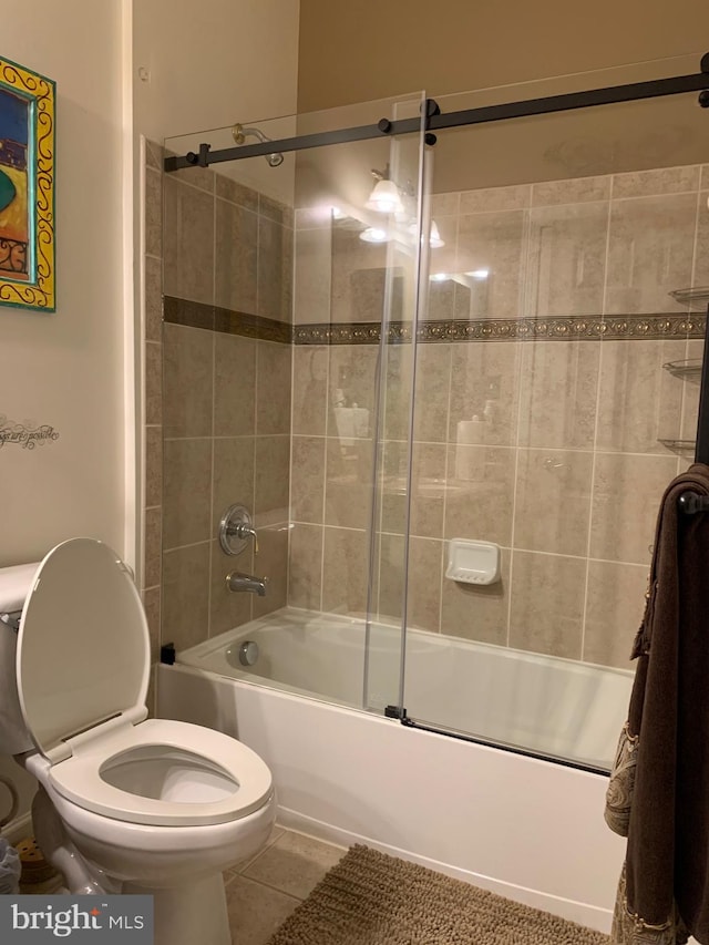 bathroom with tile patterned floors, toilet, and enclosed tub / shower combo