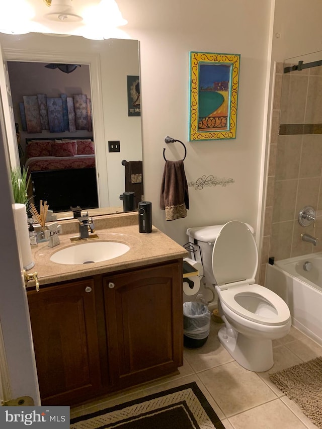 full bathroom featuring tile patterned flooring, vanity, tiled shower / bath combo, and toilet