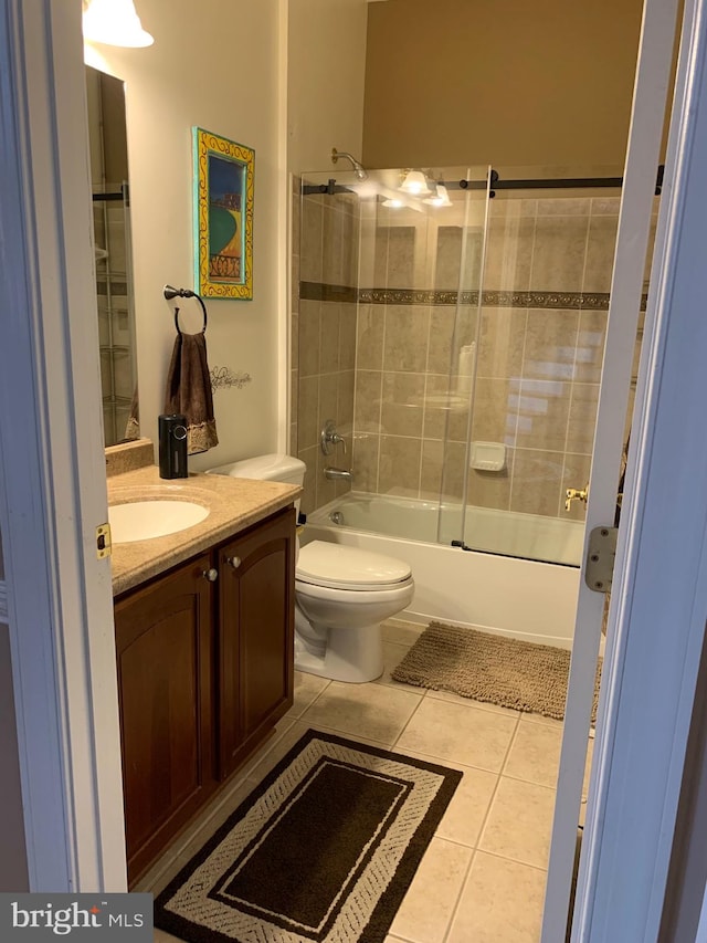 full bathroom featuring tile patterned floors, vanity, enclosed tub / shower combo, and toilet