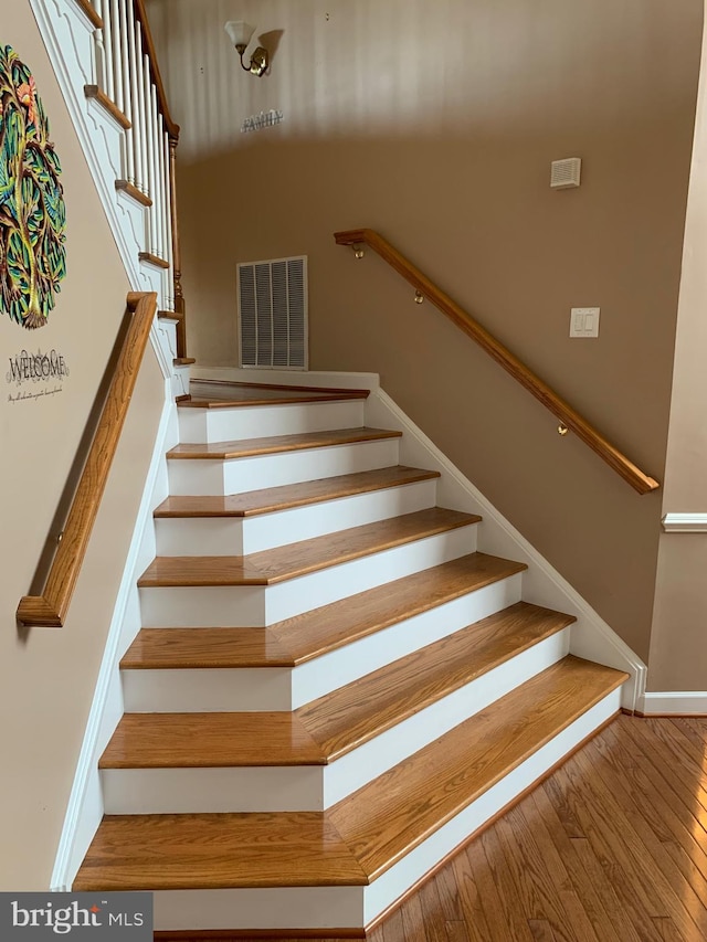 stairway featuring hardwood / wood-style flooring