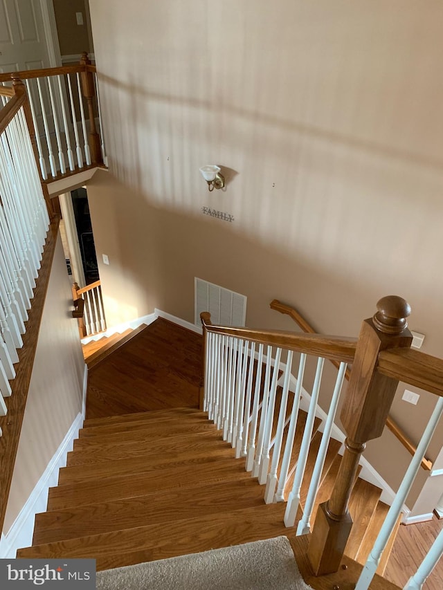 stairway featuring hardwood / wood-style floors