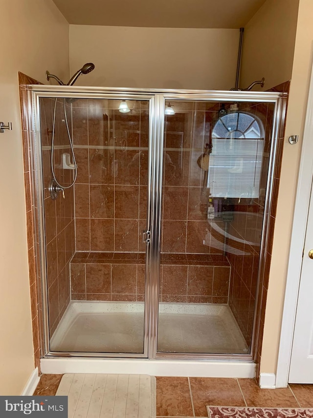 bathroom with tile patterned floors and an enclosed shower