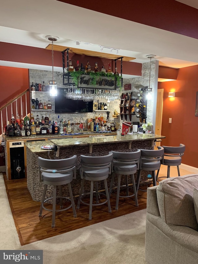 bar featuring pendant lighting and carpet floors