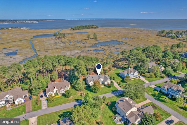 drone / aerial view with a water view and a residential view