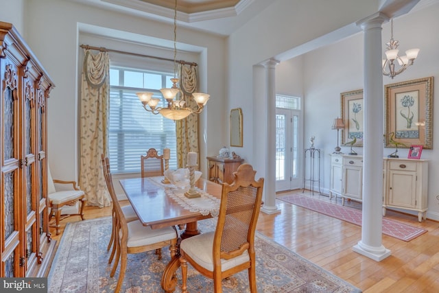 23298 Horse Island Rd, Lewes, DE 19958 - dining room with an inviting chandelier, light wood-style flooring, a wealth of natural light, and ornate columns