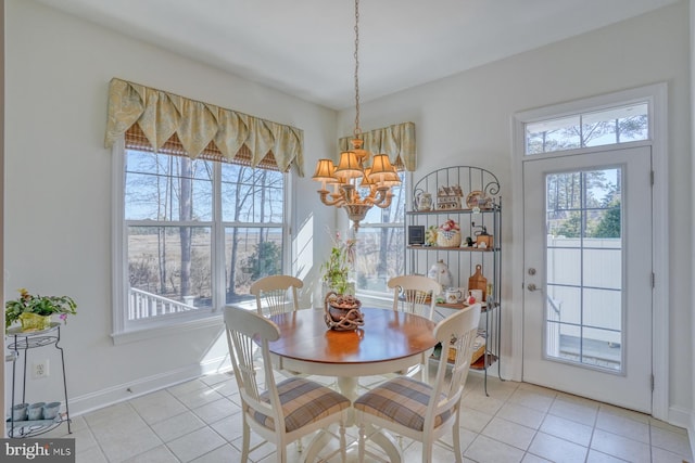 dining room featuring a wealth of natural light, light tile patterned flooring, and an inviting chandelier