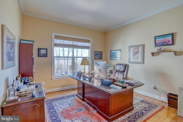 home office with baseboards, light wood-style flooring, and crown molding