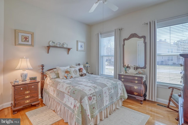 bedroom featuring light wood-style floors, baseboards, and a ceiling fan