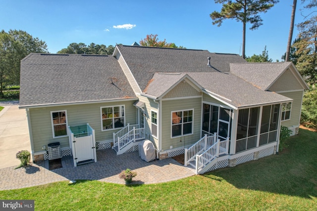 back of house featuring a yard, a patio, cooling unit, and a sunroom