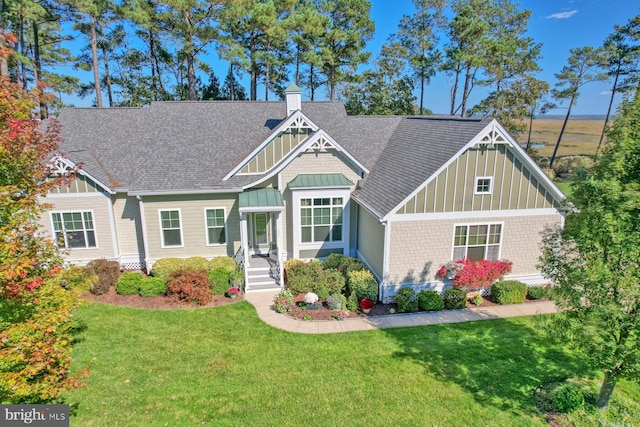 23298 Horse Island Rd, Lewes, DE 19958 - craftsman-style home featuring a front lawn, board and batten siding, roof with shingles, and a chimney