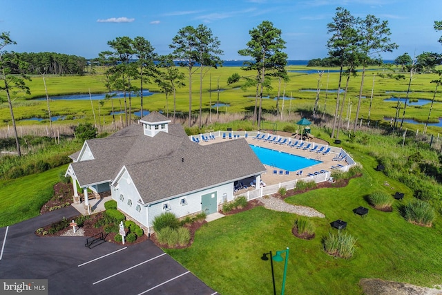 birds eye view of property featuring a water view and a rural view