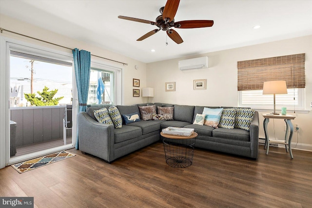 living room with dark wood-type flooring, an AC wall unit, and ceiling fan