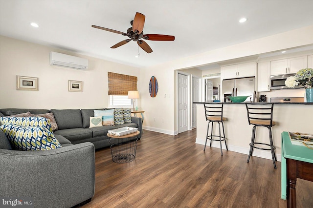 living room featuring ceiling fan, a wall mounted air conditioner, and dark hardwood / wood-style floors