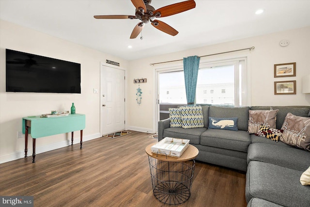 living room with ceiling fan and dark hardwood / wood-style floors