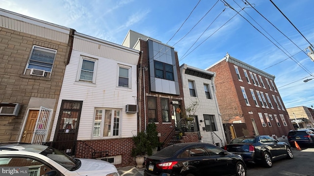 view of building exterior featuring a wall mounted air conditioner