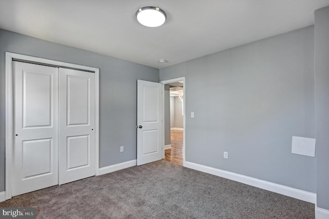 unfurnished bedroom featuring carpet and a closet